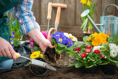 Gardeners loading separated green waste into collection bins